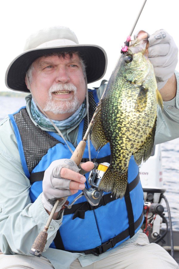 Author Darl Black (in full sun protective gear) chasing summer crappies in the tall weeds of a northern natural lake.