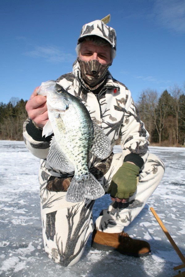 Tip-ups will not catch the numbers of crappie you’ll get going from hole to hole with a jigging stick, but by using a bigger bait they catch some pretty large crappie.