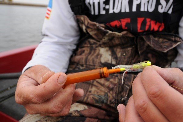 Kyle Schoenherr mixes Berkley PowerBait Crappie Nibbles and some water in a syringe to create a paste that he injects into tube baits.
