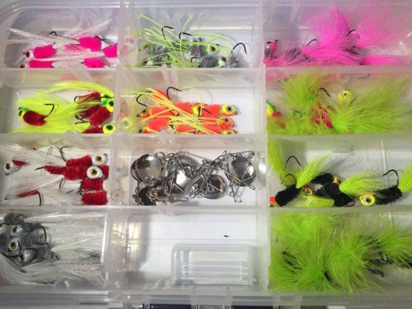 Joe Bragg ties the size and colors of jigs that are the “hot bite” for the lake he is fishing.