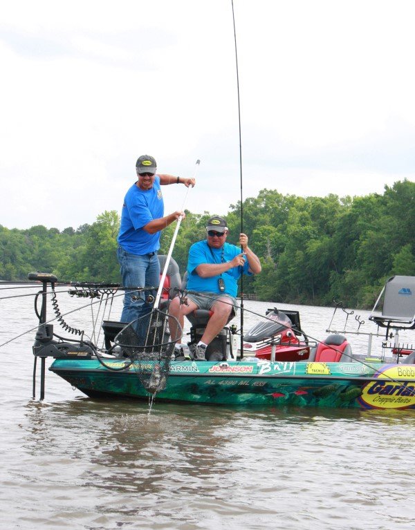 The Bobby Garland team of Garrett Steele and Dan Dannenmueller net a fish during a tournament. Dannenmueller says wrapped boats are a great way to gain attention giving the opportunity to promote a sponsor, the sport of crappie fishing, tournaments and the fisherman himself.