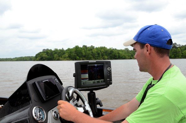 To find the crappie, Phillips uses his Humminbird side-scanning depth finder to locate logjams, sunken trees and natural brush on the edge of the main river channel.