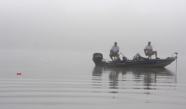 Casting is a good way to work a stump, log or bed. On a foggy morning, these fishermen are casting to cover in a creek marked with a buoy.