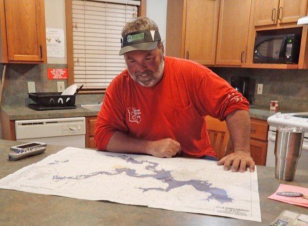 Electronic maps are key for on-the-water searching, but paper maps are still good tools for studying the lake while relaxing in your cabin.