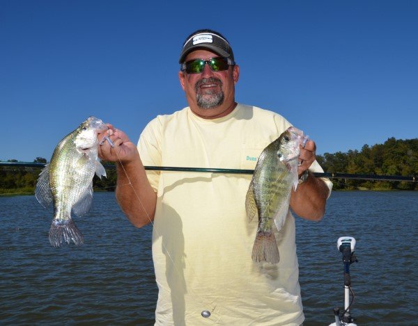 Joe Dunn shows off a couple crappie he caught while fishing on Millers Ferry Reservoir near Millers Ferry, AL.