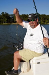 Joe Dunn shows how his rigs a double rig for crappie with two jigs, each tipped with a minnow for fishing on Millers Ferry Reservoir near Millers Ferry, AL.