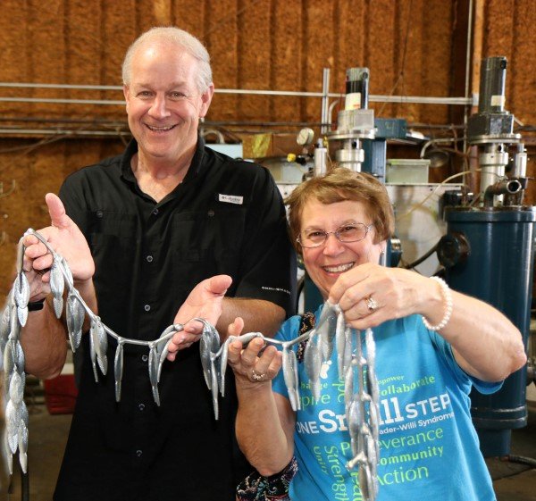 Gary Dollahon and Jeanne Huffman display a stringer of fish; Oh wait, that’s a pour of plastic baits after they come out of the mold.